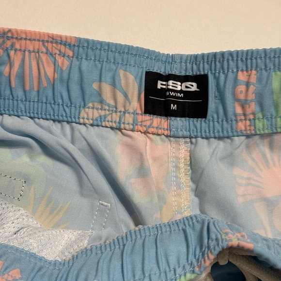 RSQ Men's Baja Swim Trunks in a light blue with a palm tree, rose, and sun print - Picture 2 of 5